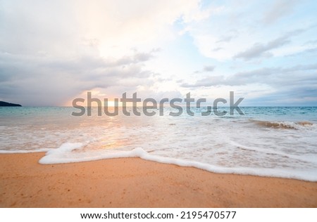 Seascape with sunset on the ocean shore. Beautiful cloudy sky.