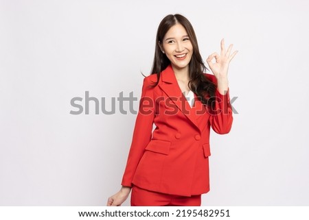 Asian businesswoman smiling and showing OK sign isolated on white background