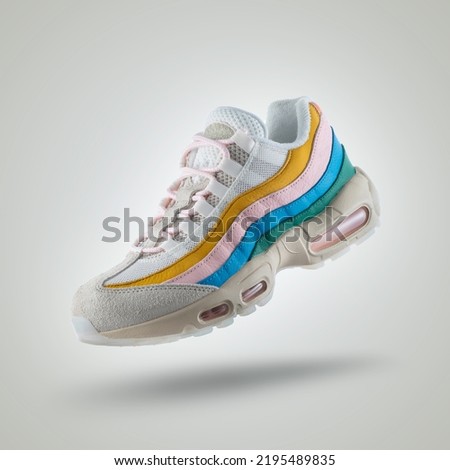 
White sneaker with a diversity of colors, shoe on a white gradient background, Yellow, pink, blue, green Royalty-Free Stock Photo #2195489835