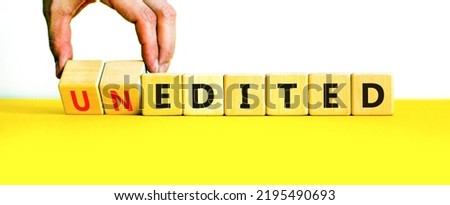Edited or unedited symbol. Businessman turns wooden cubes and changes the word unedited to edited. Business and edited or unedited concept. Beautiful white background, copy space.