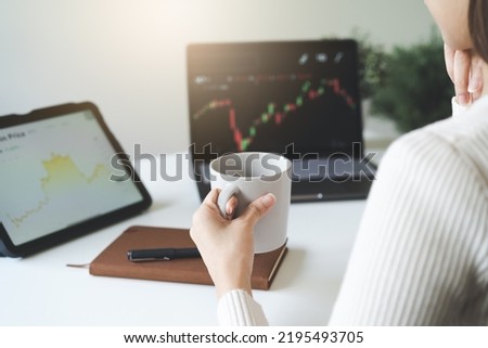 Financial investment in exchange stock concept, Young woman investor looking at laptop monitor to research the stock market on the digital marketplace platform at home. Royalty-Free Stock Photo #2195493705