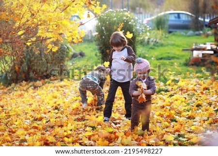Young family on a walk in the autumn park on sunny day. Happiness to be together.