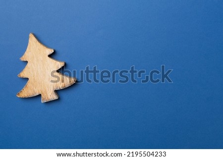 Wooden Christmas tree on color background, top view.