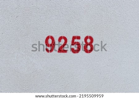 Red Number 9258 on the white wall. Spray paint.
