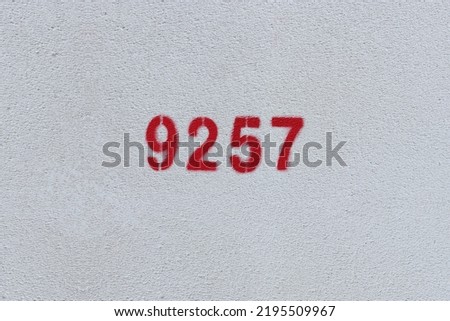 Red Number 9257 on the white wall. Spray paint.
