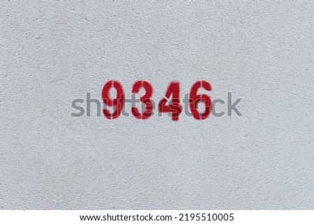 Red Number 9346 on the white wall. Spray paint.
