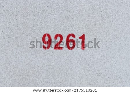 Red Number 9261 on the white wall. Spray paint.

