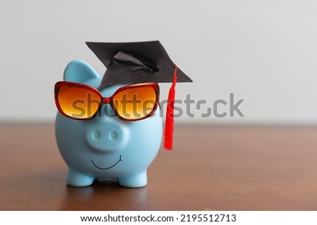 College graduate student diploma piggy bank.
