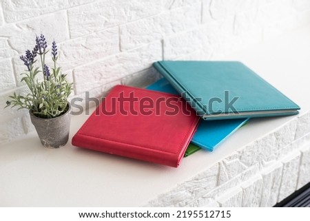 Luxury photo books in a leather cover on natural background.
