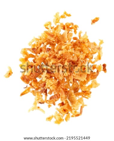 Roasted onions isolated on white background. Crispy fried onions. Top view. Royalty-Free Stock Photo #2195521449