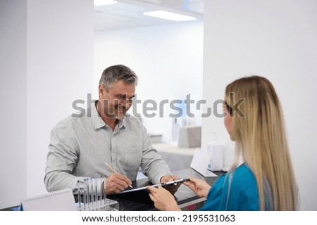 Doctor gives the patient to fill out a questionnaire