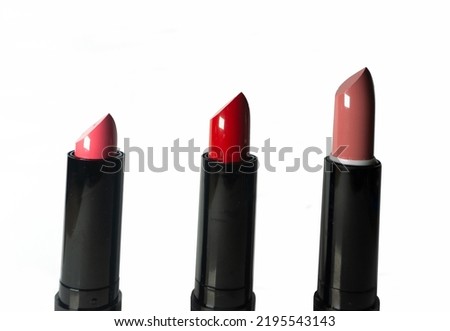 Collection of lipsticks in a black case on a white background.

