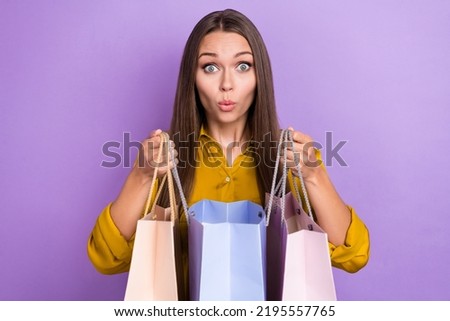 Photo of impressed young lady open bags card wear yellow shirt isolated on purple color background