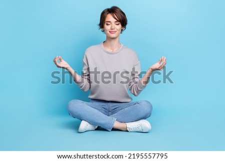Full size photo of short hairdo millennial lady sit rest wear shirt jeans shoes isolated on blue color background