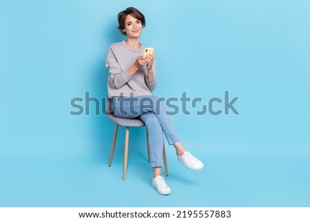 Full length size photo of pretty cute stylish lady wear trendy clothes use telephone device empty space isolated on blue color background