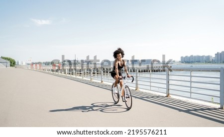 Cyclist woman rides a road bike fitness training, eco transport