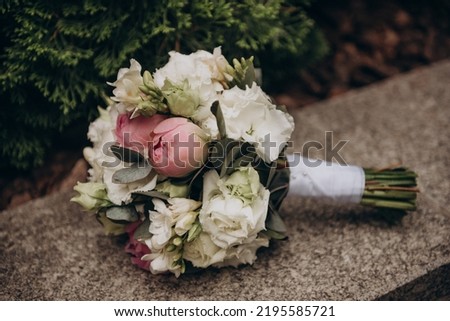 Wedding bouquet for the bride, consists of: cream roses, peonies, green eucalyptus leaves. Wedding, holiday.