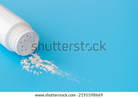 Talcum powder in container. Spilled white powder Royalty-Free Stock Photo #2195598669
