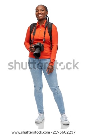 people, profession and photography concept - happy smiling woman photographer with digital camera and backpack over white background