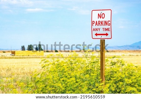 A no parking sign at the side of a highway in California, USA.