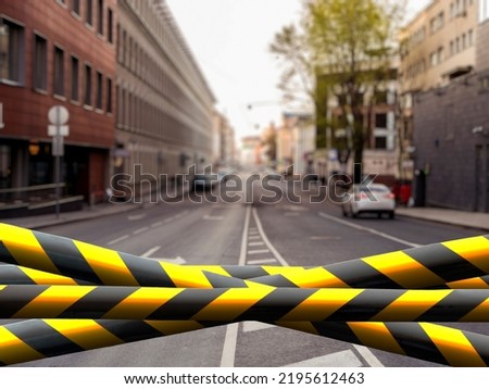 black and yellow safety tape outdoors in the street, restricted area