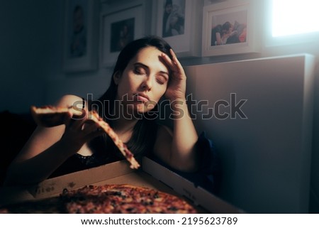 

Stressed Tired Woman Having a Slice of Pizza at Night. Unhappy tired depressed person binge eating during nighttime
 Royalty-Free Stock Photo #2195623789