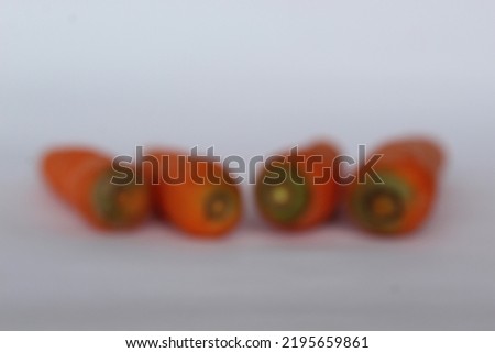 The photo does not focus on the carrot object as an aesthetic background for art and abstract presentation. Reduce focus on objects.