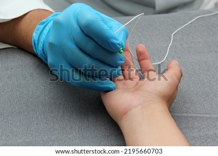 Electromyography is a graphic recording technique of the electrical activity of the muscles known as electromyogram or EMG, it is monitored through intramuscular electrodes Royalty-Free Stock Photo #2195660703