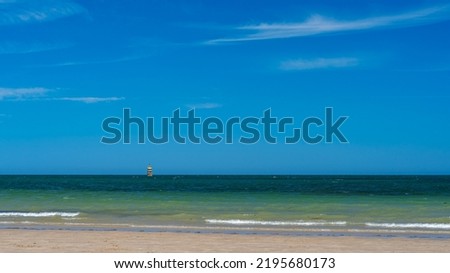 Beautiful panorama with beach, sea, pilot of navigation and sky on summer day at sunset.