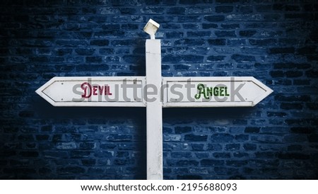 Street Sign the Direction Way to Angel versus Devil Royalty-Free Stock Photo #2195688093