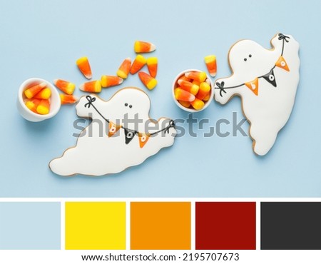 Tasty candies and cookies for Halloween on light background. Different color patterns