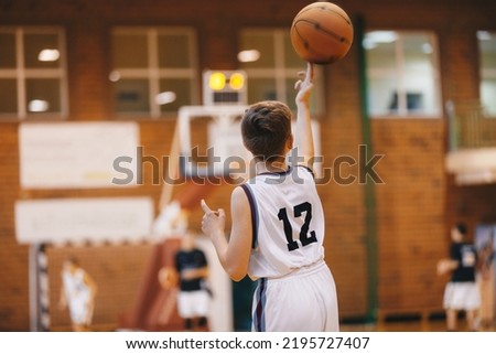 Boy Playing With Basketball on Training Session. Happy Kids on Basketball Training Practice. Group of School Basketball Players Having Fun