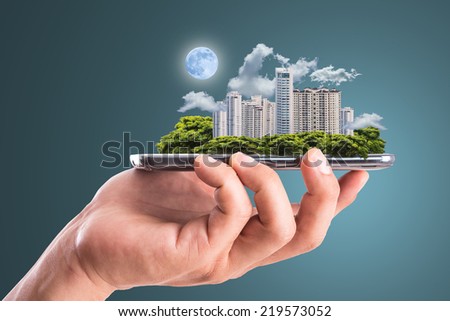 Cityscape intelligent building ,hold smart phone for build and make your green city. Royalty-Free Stock Photo #219573052