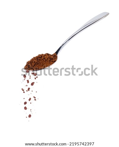Pouring instant coffee or coffe powder from stainless teaspoon isolated on white background. Royalty-Free Stock Photo #2195742397