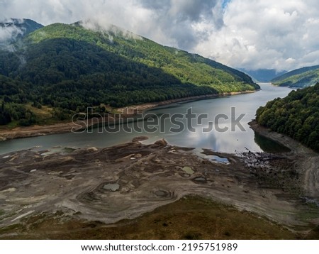 Aerial view of the Poiana Marului Lake shore during the summer drought who has hit Europe. Photo taken on 31st of July 2022 in Poiana Marului reservation, Caras-Severin County, Romania. Royalty-Free Stock Photo #2195751989