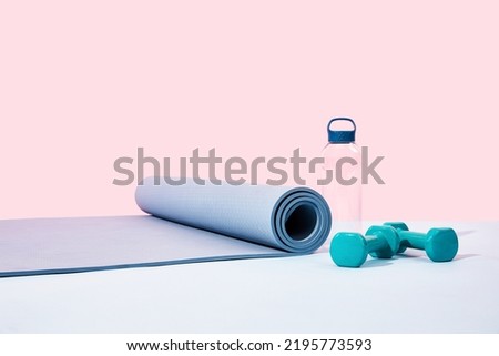 Fitness exercise equipment in front of pink background Royalty-Free Stock Photo #2195773593