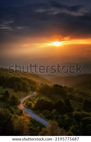 Beautiful summer mountain landscape, clouds and sun rays at sunset