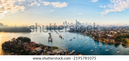 Parramatta river bays in Sydney city at sunny morning with fog in short aerial panorama towards City of Sydney CBD skyline high-rise towers. Royalty-Free Stock Photo #2195781075