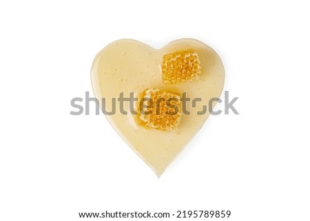 Honey on honeycomb in a heart isolated on white background. Natural honey, organic bee product with clipping path. Love honey concept