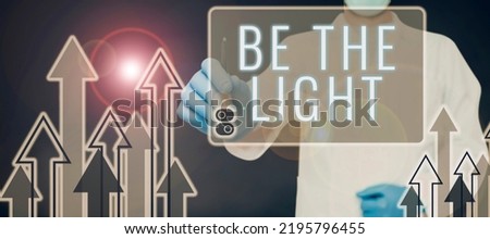 Text caption presenting Be The Light. Conceptual photo Enlighten other showing with your attitude be optimistic Doctor Pointing Pen On Digital Display With Arrows Moving Up.