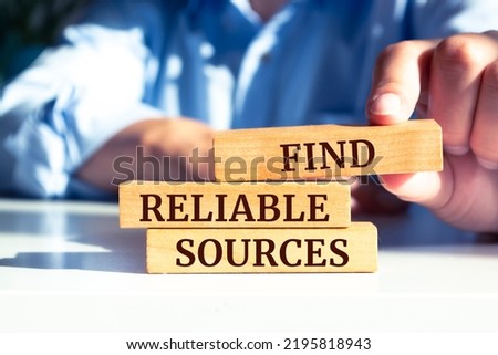 Wooden blocks with words 'Find reliable sources'. Business concept