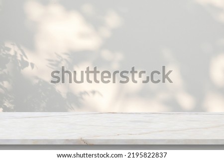 Marble table with tree shadow drop on white wall background for mockup product display Royalty-Free Stock Photo #2195822837