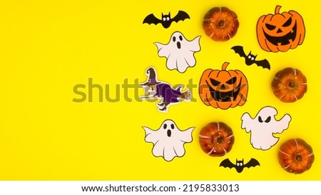 Creative yellow background with copy space and Halloween stickers. Flat lay