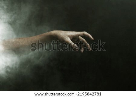 Zombie hand on dark background Royalty-Free Stock Photo #2195842781