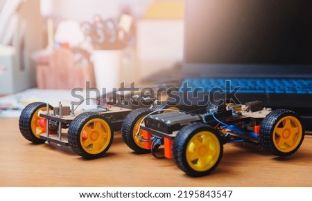 Homemade toy cars with microcontroller for teaching engineers to children. Royalty-Free Stock Photo #2195843547