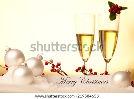 Christmas decoration with two champagne glasses against beautiful background. Useful as a christmas card.