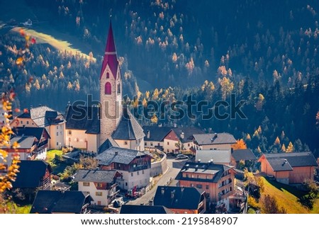 Astonishing autumn view of  Pfarrei Maria vom Guten Rat Christian church, Italy, Europe. Spectacular morning scene of Dolomite Alps. Traveling concept background.