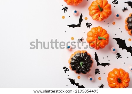 Top view photo of halloween party accessories pumpkins creepy eyeballs bats skull crossed bones silhouettes spiders and confetti on isolated white background with copyspace