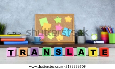 Word Translate made of colorful cubes with letters on white wooden table
