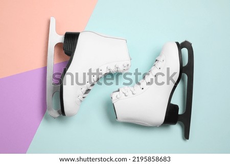 Pair of skates on color background, flat lay